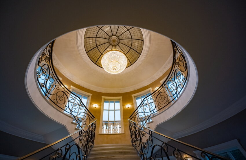 Pear-shaped crystal light above the staircase complemented by matching wall lights