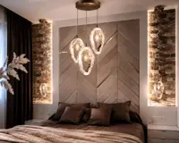 Cluster of hanging glass lights above the bed in a bedroom with stone-clad walls