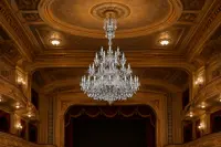 Large multi-tier crystal chandelier in a historic theatre hall