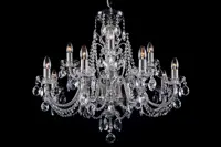 Silver crystal chandelier with cut-glass pendants on a black background