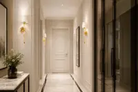 Gold wall lamp in an elegant hallway interior