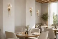 Gold wall lamp in a modern dining room interior