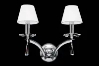 Silver brass wall light with cut crystal pendants on a black background