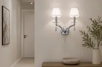 Wall light illuminating a hallway beside a door in a modern interior