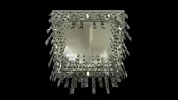 Rectangular ceiling chandelier with cascading crystal prisms in silver finish on black background