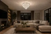 Round crystal ceiling light with layered pendants above a corner sofa in a modern living room with a fireplace